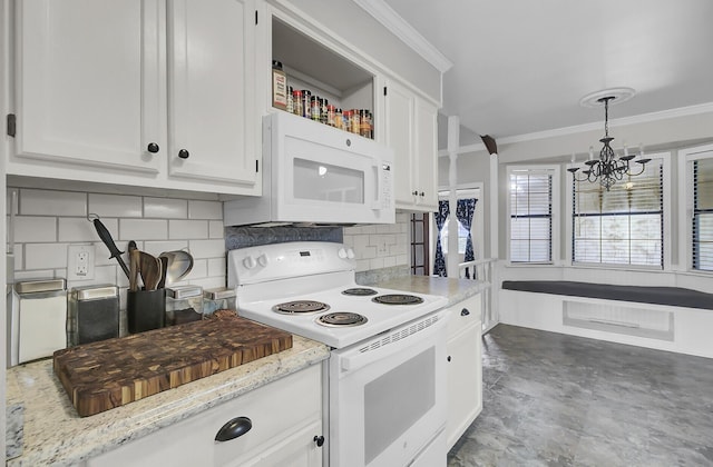 kitchen featuring crown molding, backsplash, an inviting chandelier, white cabinetry, and white appliances