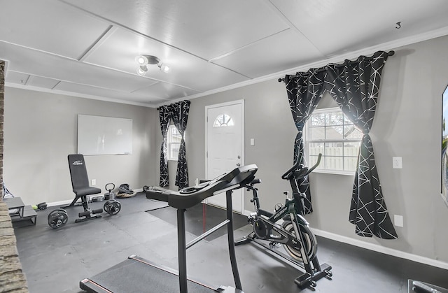 workout area with crown molding and baseboards