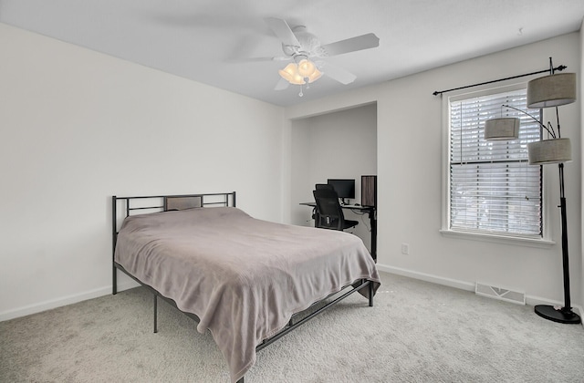 carpeted bedroom with baseboards, visible vents, and a ceiling fan