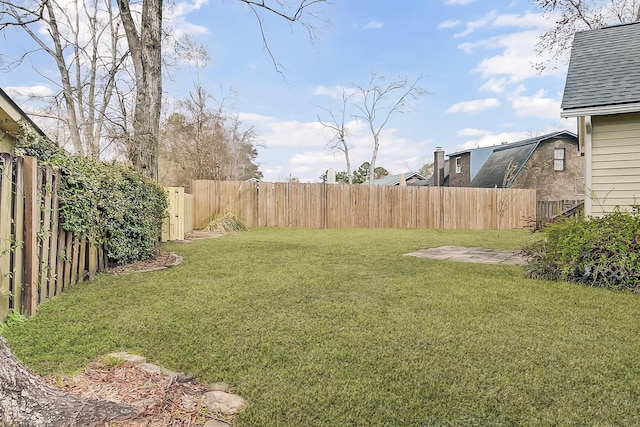 view of yard with a fenced backyard