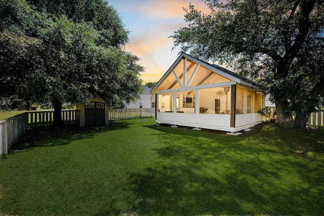 1136 Peninsula Cove Dr, Charleston, SC 29492 - rear view of property with a storage unit, a sunroom, and an outbuilding