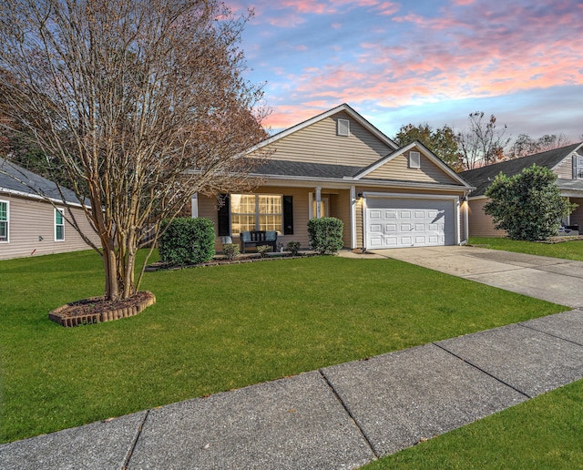 view of front of property featuring a yard and a garage