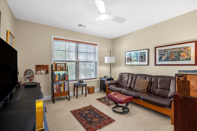 carpeted living room with ceiling fan