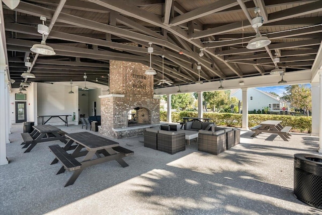 view of patio featuring a gazebo, an outdoor living space with a fireplace, and ceiling fan