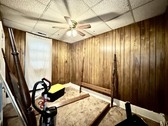 3 Hanover St, Charleston, SC 29403 - exercise room with a paneled ceiling, wooden walls, a ceiling fan, and carpet flooring