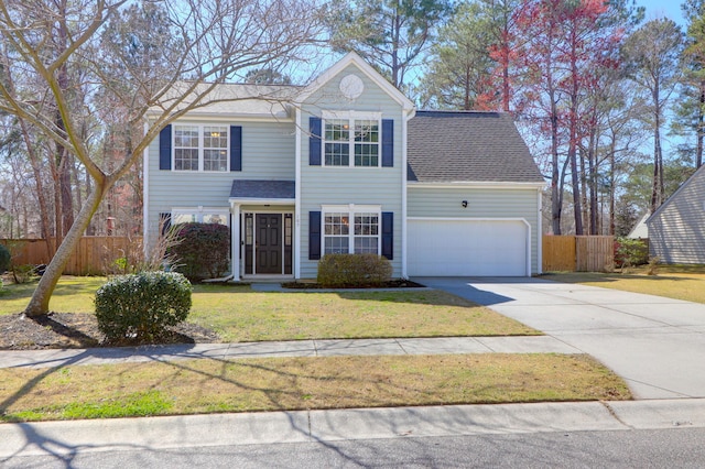 traditional-style home featuring fence, roof with shingles, a front lawn, concrete driveway, and a garage