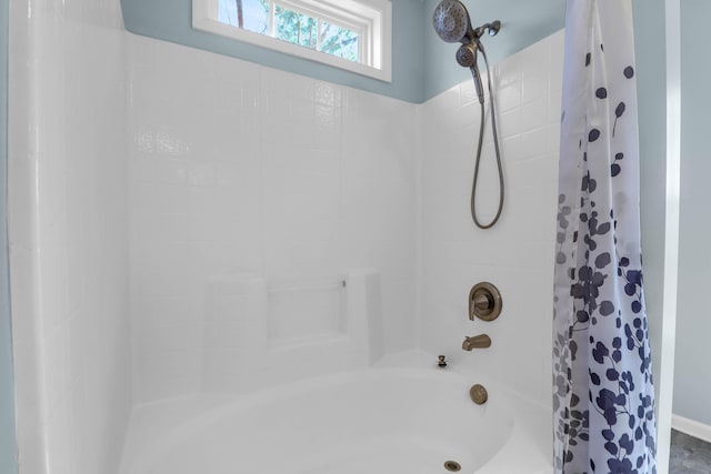 bathroom with shower / bath combination with curtain