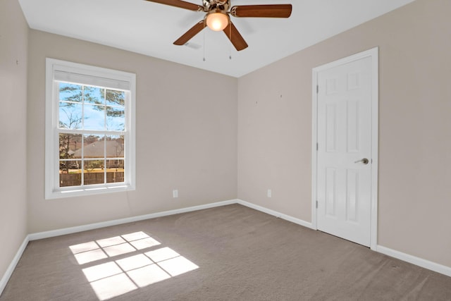 spare room with a ceiling fan, baseboards, and carpet floors