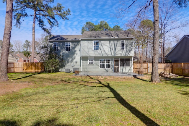 back of house featuring a lawn, a patio, a fenced backyard, a sunroom, and central AC unit