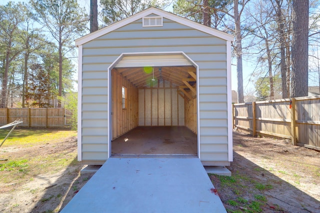 view of shed featuring fence