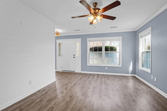 interior space with crown molding, dark wood-style floors, visible vents, and baseboards