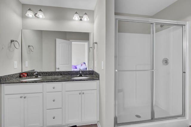 bathroom with walk in shower and vanity