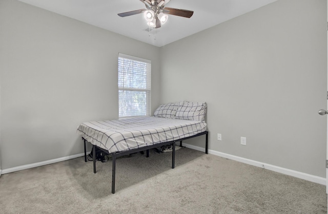 bedroom with ceiling fan and light carpet