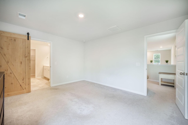 452 Minim St, Charleston, SC 29414 - unfurnished bedroom featuring carpet, recessed lighting, baseboards, and a barn door