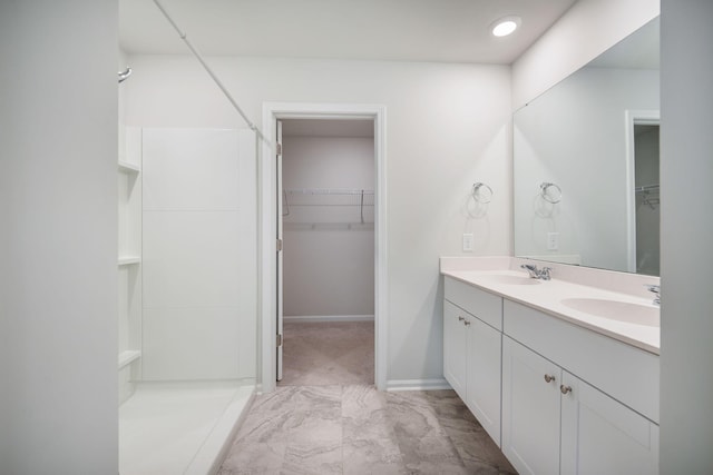 452 Minim St, Charleston, SC 29414 - full bath with double vanity, a spacious closet, a shower, marble finish flooring, and baseboards