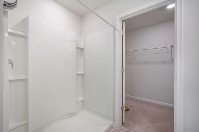 452 Minim St, Charleston, SC 29414 - bathroom with a shower stall, a walk in closet, and baseboards