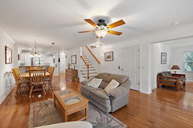 living room with crown molding, hardwood / wood-style flooring, and ceiling fan