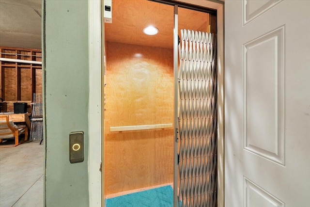 interior details featuring elevator and wood walls