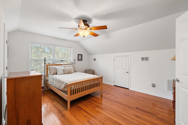 bedroom featuring hardwood / wood-style floors, ceiling fan, and vaulted ceiling