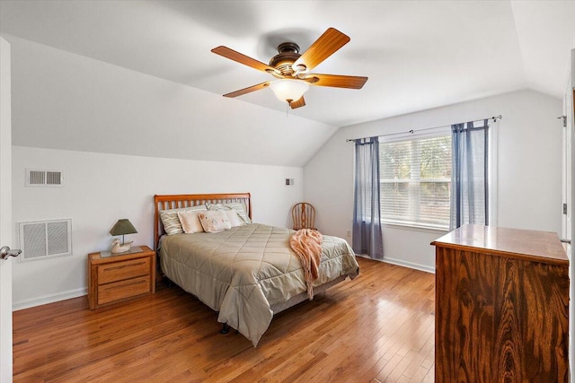 bedroom with light hardwood / wood-style floors, ceiling fan, and vaulted ceiling