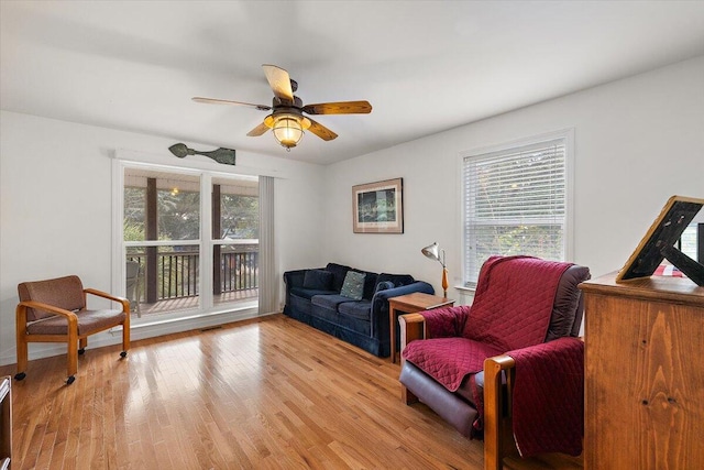 sitting room with light wood-type flooring and ceiling fan