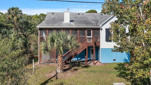 back of property with a sunroom and a yard