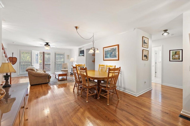 dining space featuring ceiling fan and light wood-type flooring