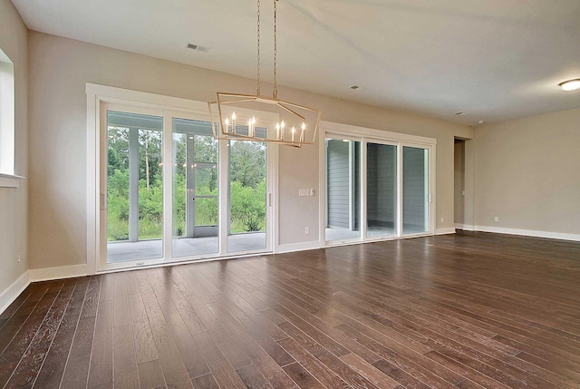 interior space with an inviting chandelier and dark wood-type flooring