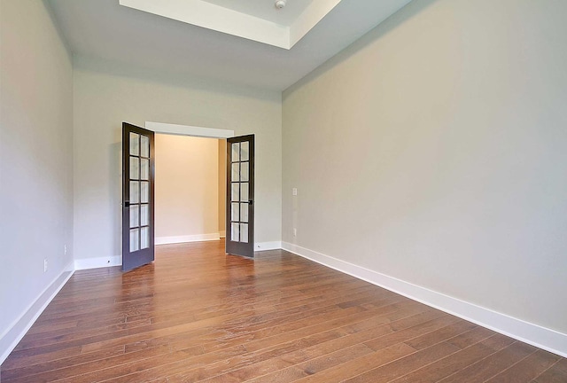 spare room featuring french doors and dark hardwood / wood-style flooring