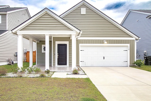 view of front of home with a porch, concrete driveway, an attached garage, and a front yard