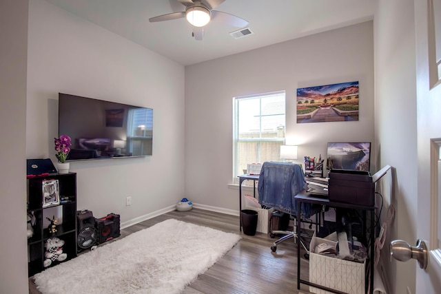 office space featuring a ceiling fan, baseboards, visible vents, and wood finished floors