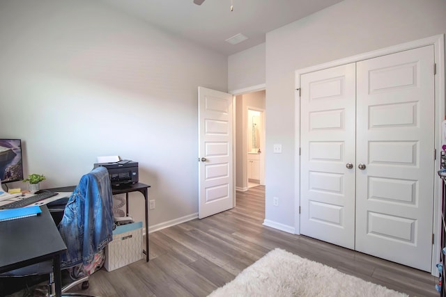 home office featuring wood finished floors, baseboards, and ceiling fan
