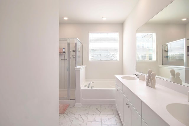 full bathroom featuring a stall shower, marble finish floor, a sink, and a bath