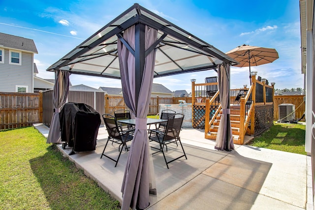 view of patio with outdoor dining area, central AC unit, a gazebo, and a fenced backyard