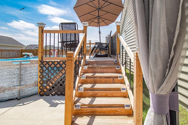 wooden deck with fence and a fenced in pool