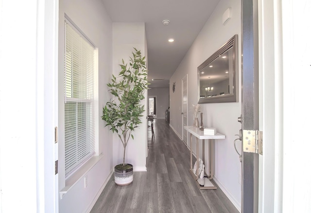 hallway featuring baseboards, dark wood-style flooring, and recessed lighting