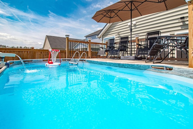 view of swimming pool featuring fence and a fenced in pool