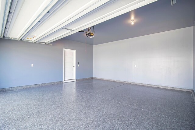garage featuring baseboards and a garage door opener