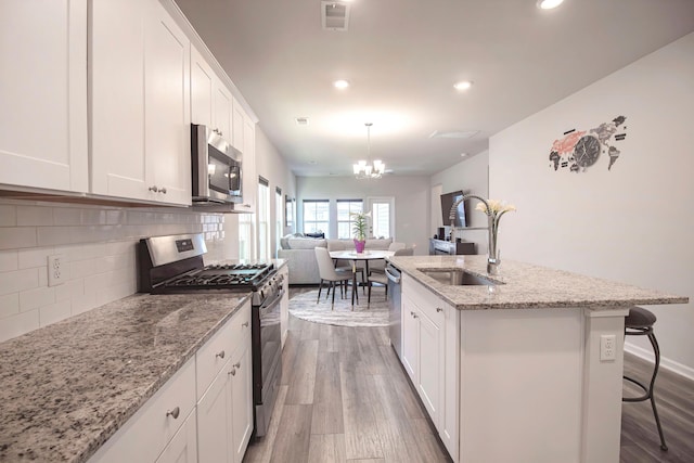 kitchen featuring a chandelier, dark wood-style floors, visible vents, and appliances with stainless steel finishes
