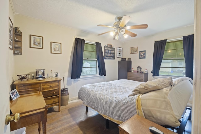 2703 Phyllis St, North Charleston, SC 29405 - bedroom featuring wood finished floors, a textured ceiling, and a ceiling fan