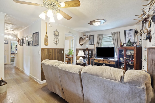 2703 Phyllis St, North Charleston, SC 29405 - living room with a textured ceiling, a ceiling fan, light wood-style floors, ornamental molding, and wainscoting