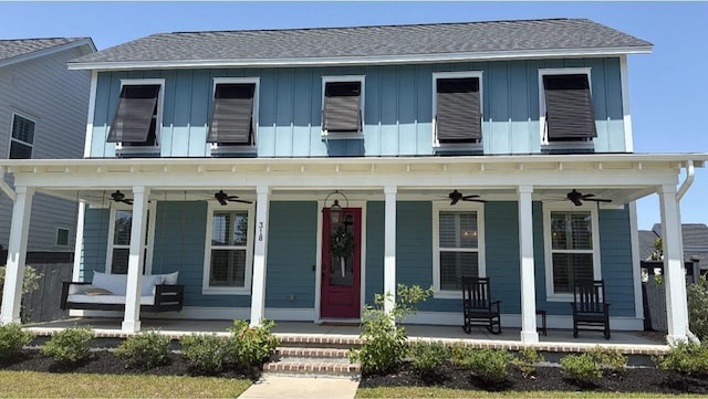 view of front facade featuring a ceiling fan, a porch, and board and batten siding