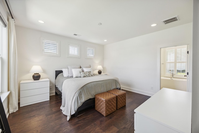 bedroom with dark wood finished floors, recessed lighting, and baseboards