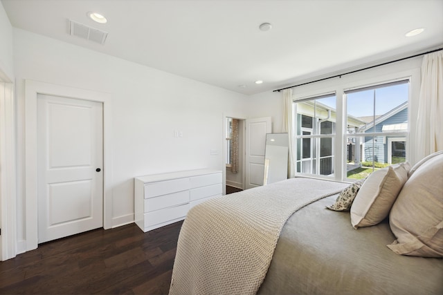 bedroom featuring dark wood-style floors, recessed lighting, and baseboards