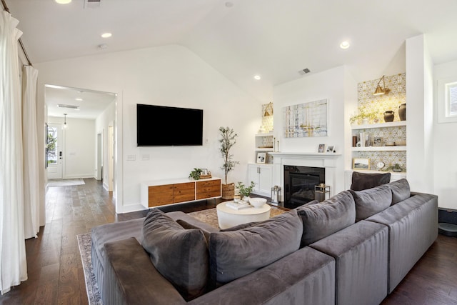 living room featuring vaulted ceiling, dark wood finished floors, a fireplace with flush hearth, recessed lighting, and baseboards