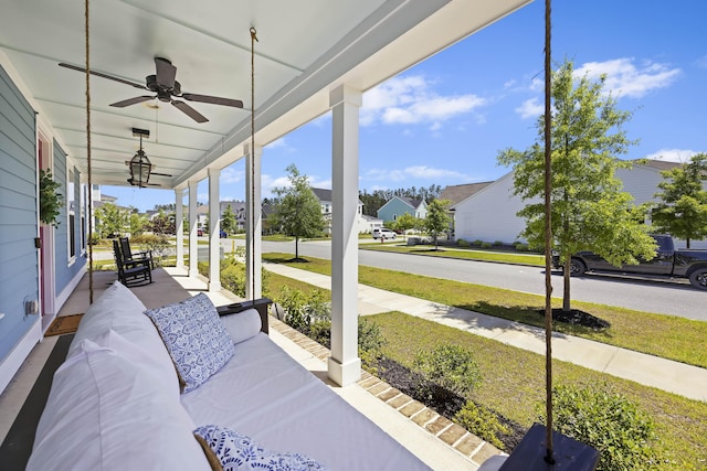 sunroom with a ceiling fan and a residential view
