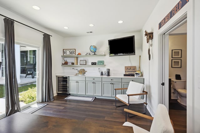 bar area with wine cooler, dark wood-type flooring, recessed lighting, a sink, and baseboards