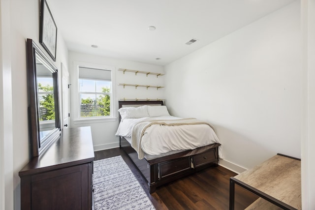 bedroom featuring dark wood-style floors and baseboards