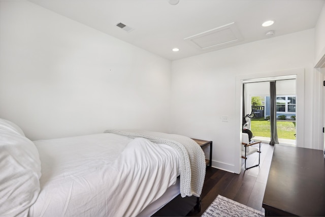 bedroom featuring attic access, wood finished floors, recessed lighting, and baseboards