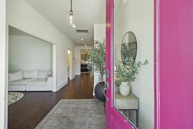 corridor with wood finished floors and baseboards